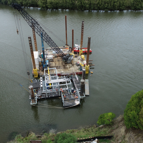 Commercial Pontoons with crane on river in New Zealand