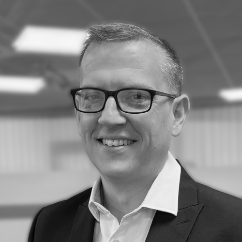 Headshot of David Coyle in black and white