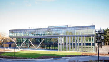 Large, glass fronted building on a sunny day