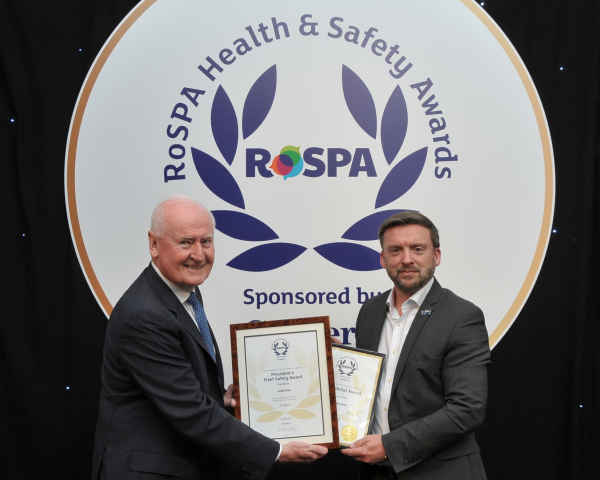 A man receiving a safety award on stage