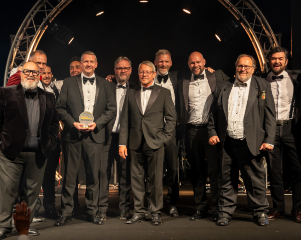 Men in suits on a stage.