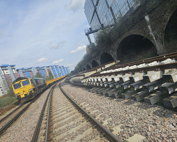 Track with new track next to it and a freight train