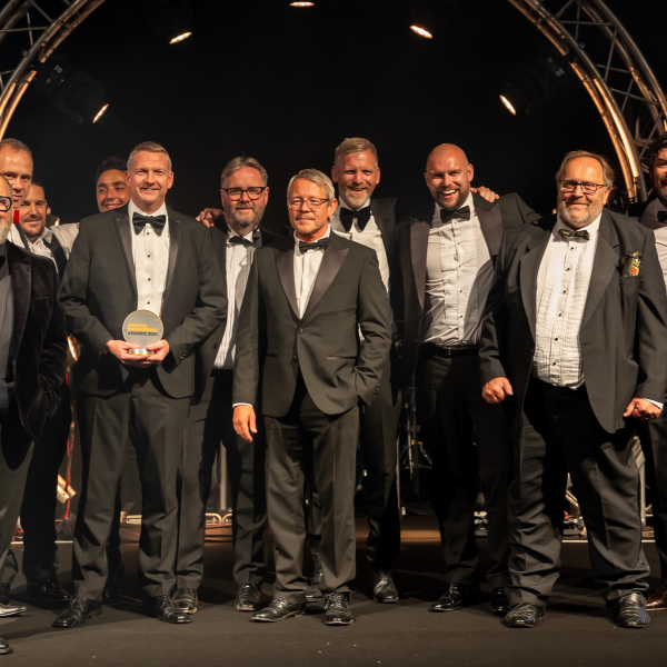 Men in suits on a stage.