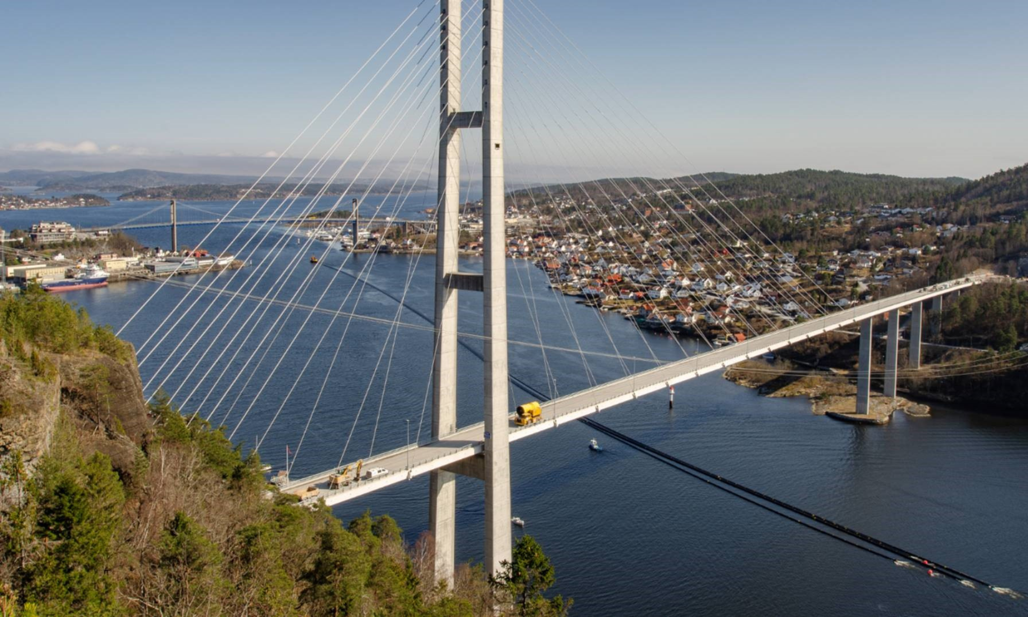 Aerial showing a duct tow under a bridge