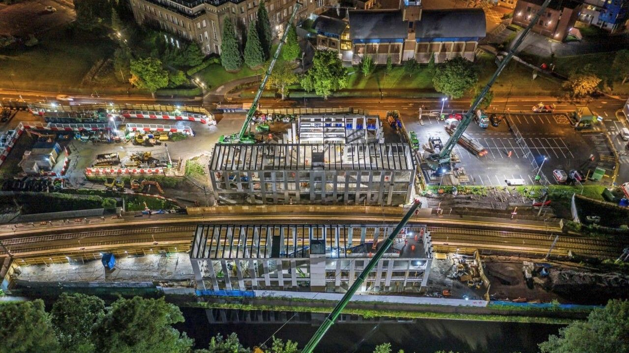 Night show of a station being build with a crane in view